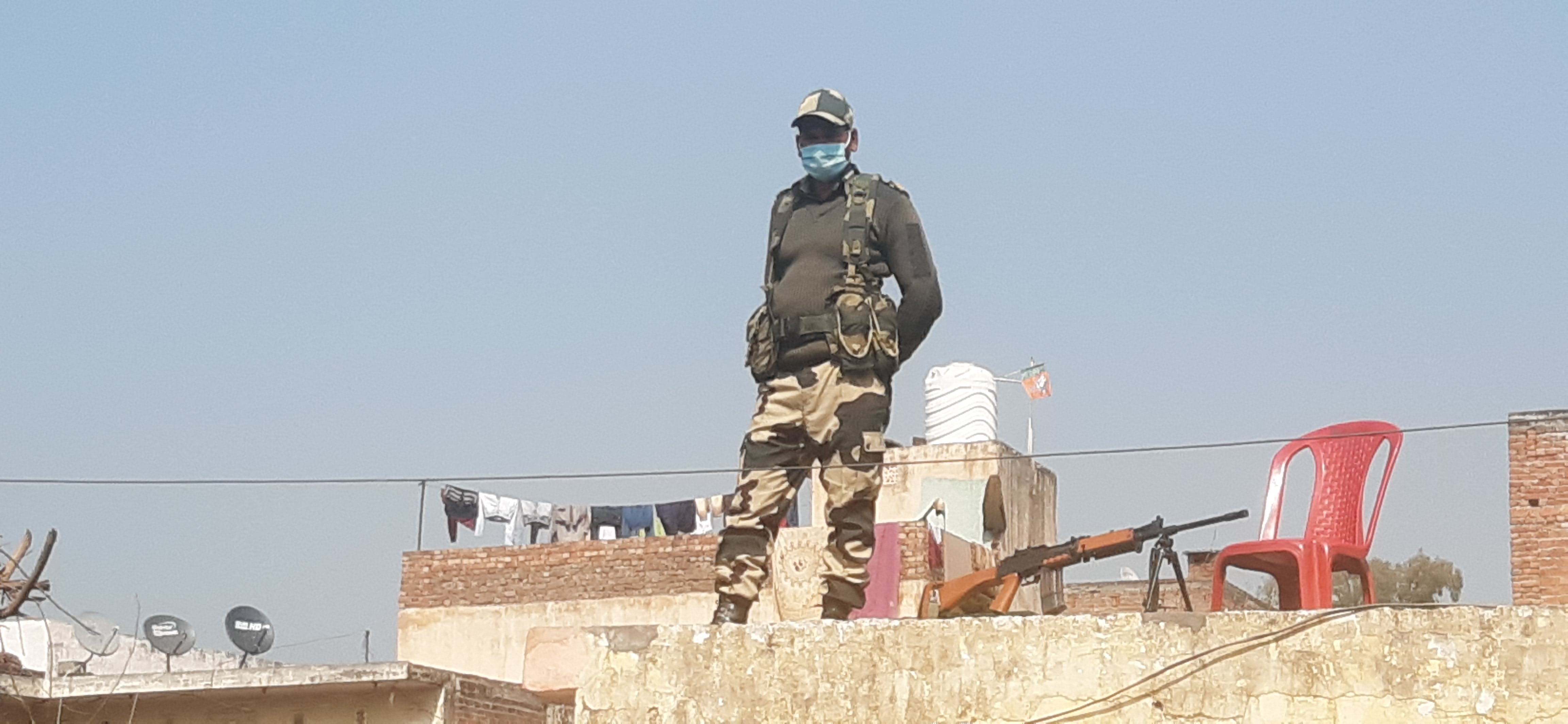 मतदान के दौरान छत से सुरक्षा की मान संभालता जवान मतदान के दौरान छत से सुरक्षा की मान संभालता जवान