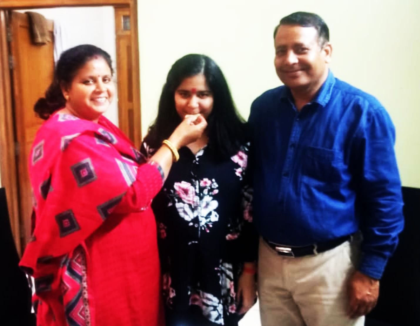 यूक्रेन से लौटने के बाद अंशिका को मिठाई खिलाते उसकी मां वंदना यादव पिता डा. अमीर सिंह । संवाद
