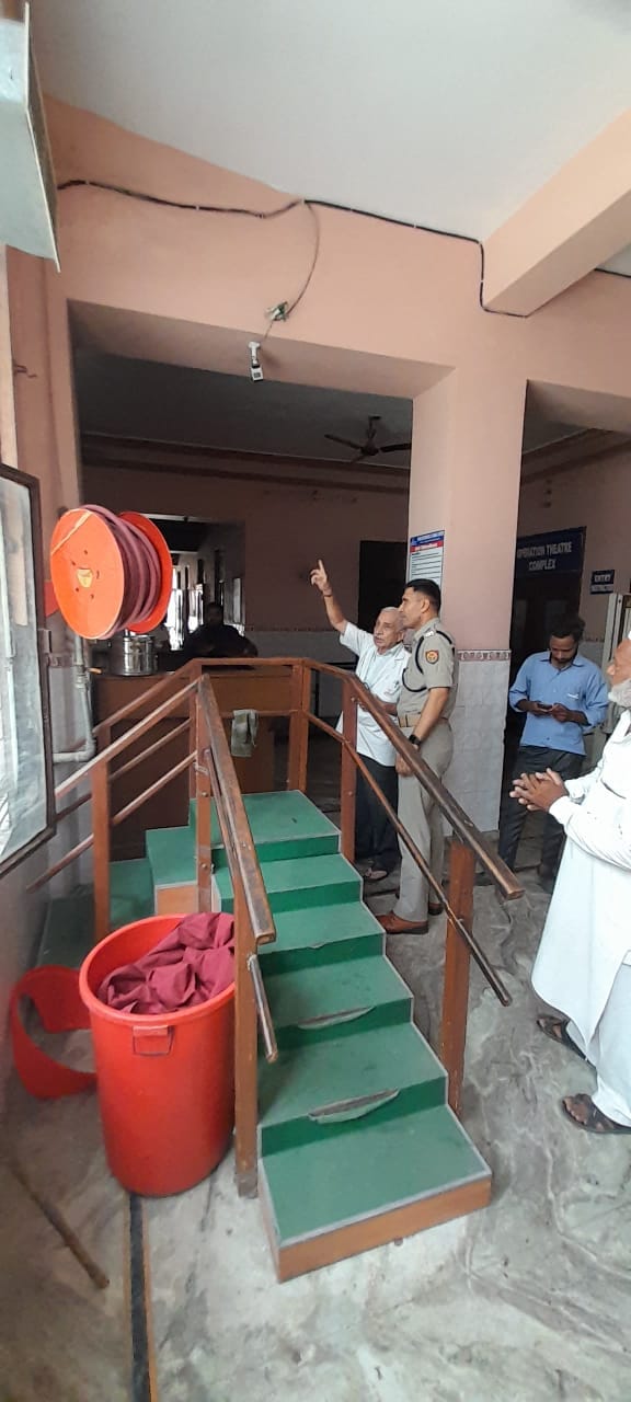 एक बिल्डिंग में अग्निशमन यंत्र का निरीक्षण करते फायर अधिकारी एक बिल्डिंग में अग्निशमन यंत्र का निरीक्षण करते फायर अधिकारी