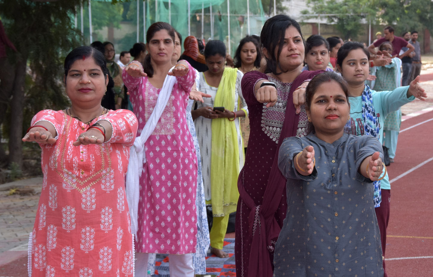 स्टेडियम में योग दिवस पर आयोजित योग कार्यकर्म में योग करती महिलाएं स्टेडियम में योग दिवस पर आयोजित योग कार्यकर्म में योग करती महिलाएं