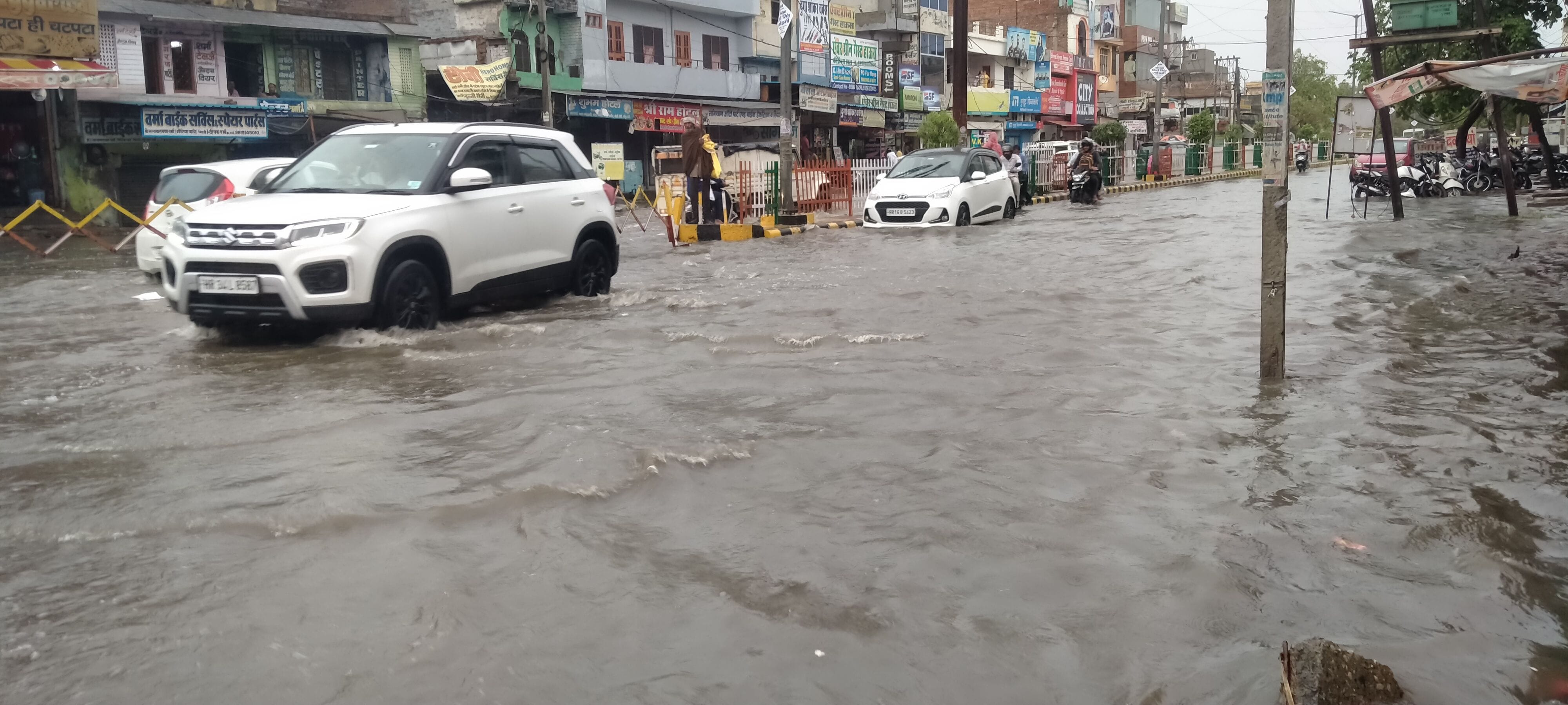 परशुराम चौक के समीप सड़क पर भरे पानी से गुजरती गाड़ियां। परशुराम चौक के समीप सड़क पर भरे पानी से गुजरती गाड़ियां।