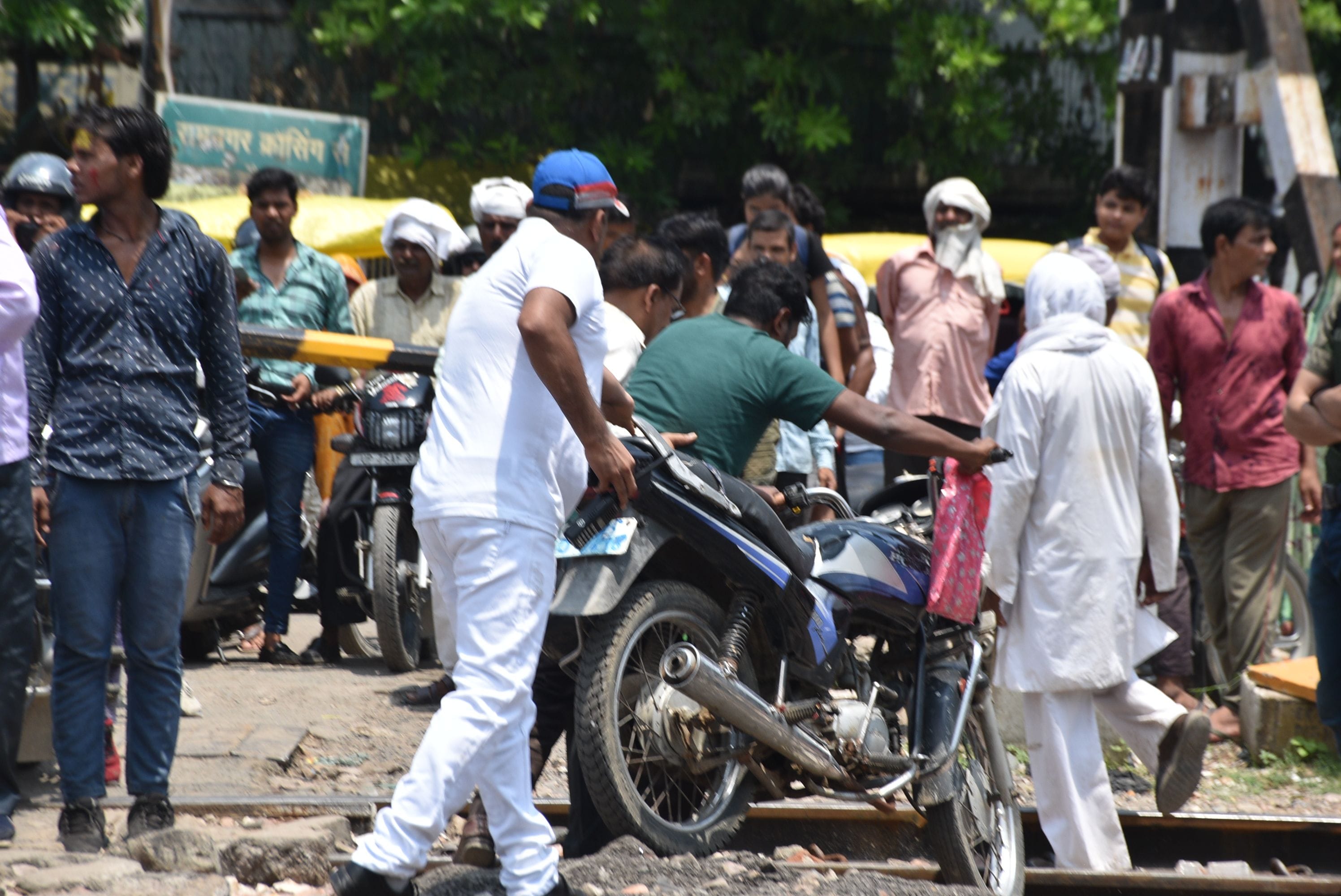 रेलवे ट्रेक में फसी बाइक को निकलवाते स्टेशन मास्टर पीएम मीणा। संवाद रेलवे ट्रेक में फसी बाइक को निकलवाते स्टेशन मास्टर पीएम मीणा। संवाद