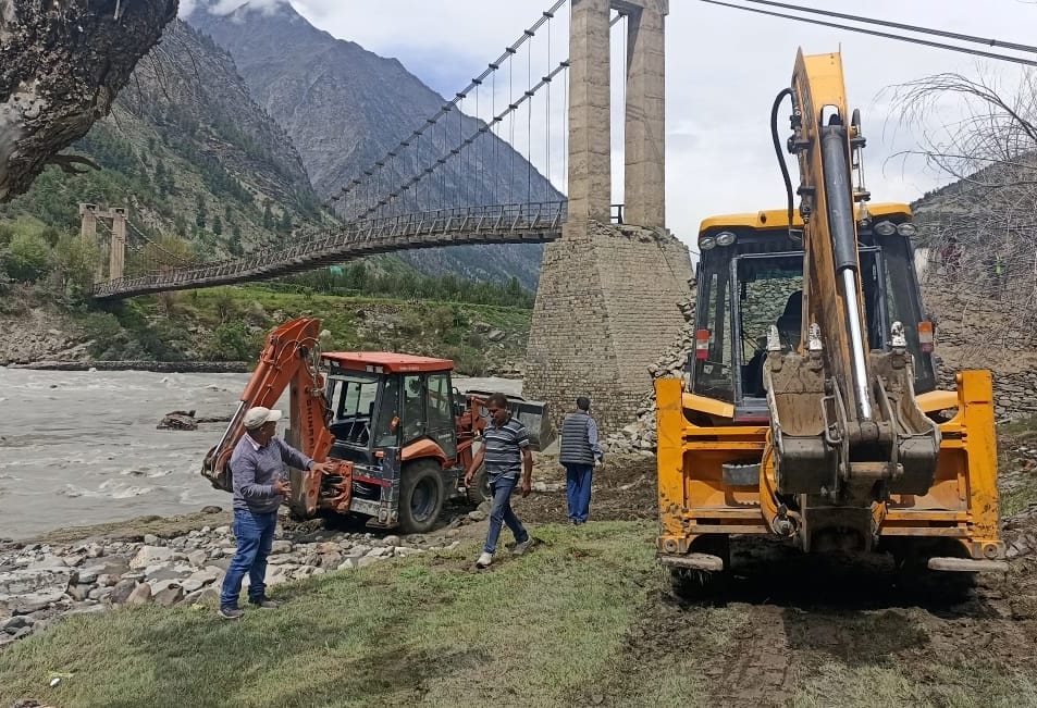लाहौल में क्षतिग्रस्त हुए जसरथ पुल के हिस्से को ठीक करने के लिए पहुचें जेसीबी।-संवाद