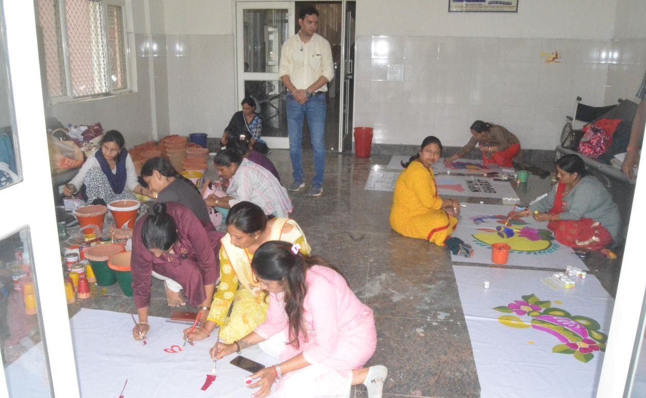 सीएम के निरीक्षण के लिये जिला अस्पताल में पेंटिग बनाती शिक्षिकायें। संवाद
