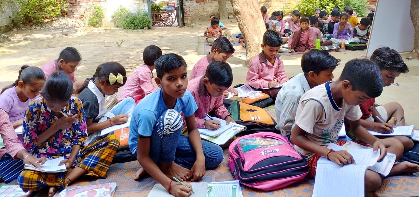 उझानी में खुले आसमान के नीचे पढ़ाई करते बच्चे। संवाद