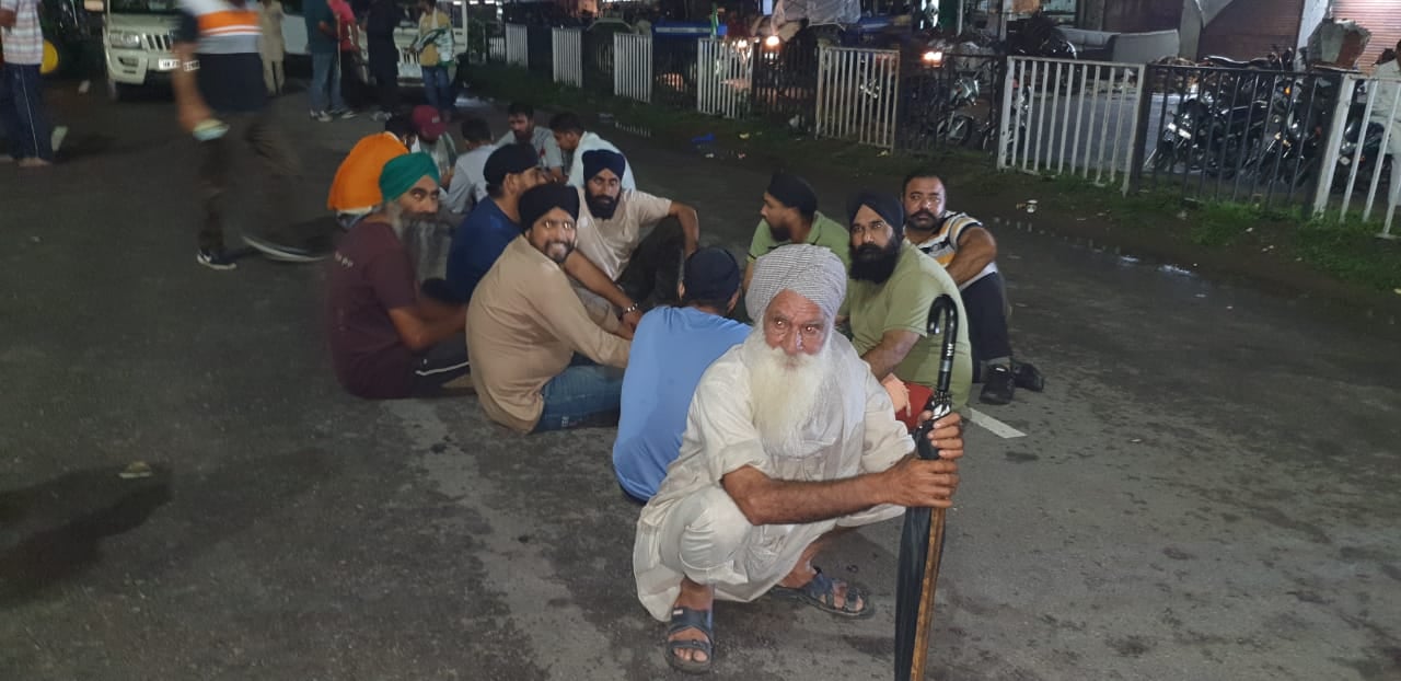 हाईवे पर जाम के दौरान देर रात को टोलियां बनाकर बैठे किसान।  संवाद