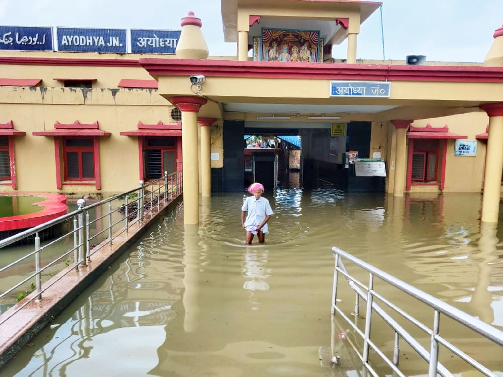 अयोध्या-रेलवेस्टेशन पर जलभराव से होकर बाहर आते लोग।-संवाद अयोध्या-रेलवेस्टेशन पर जलभराव से होकर बाहर आते लोग।-संवाद