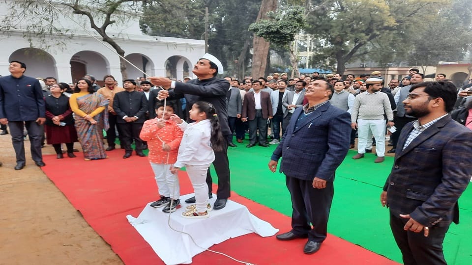 डीएम ध्वजारोहण करते हुए