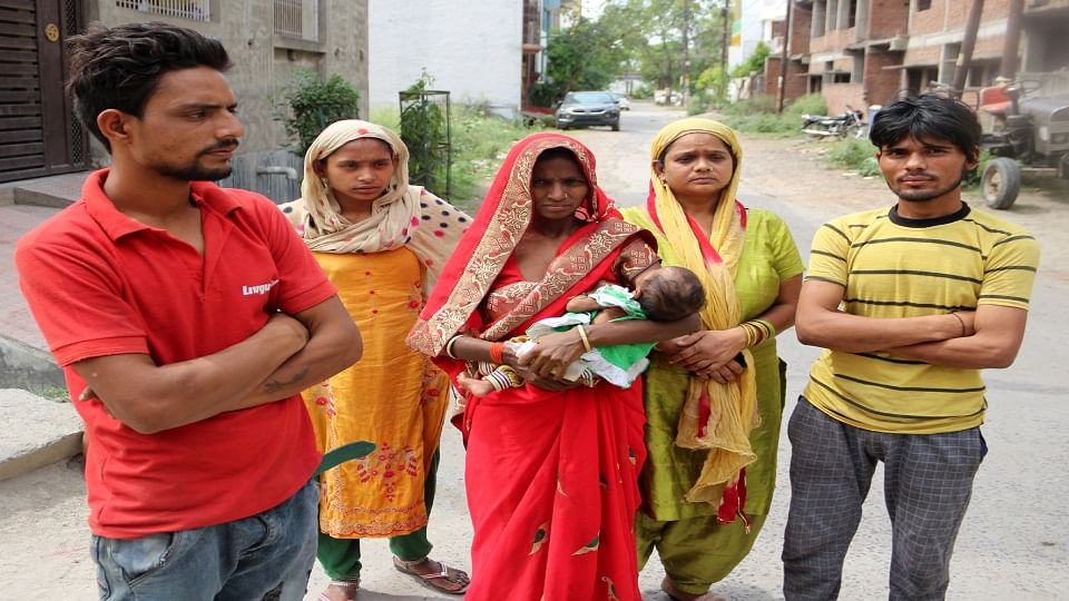 बच्ची पर कुत्तें के हमले से हुई मौत के बाद घटना स्थल पर खड़े परिजन