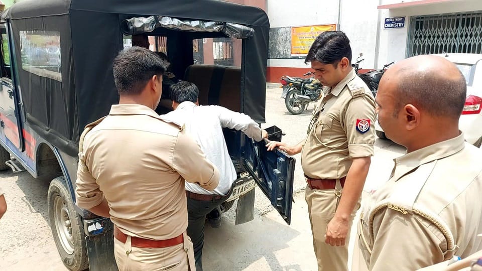 प्रोफेसर को थाने ले जाती पुलिस