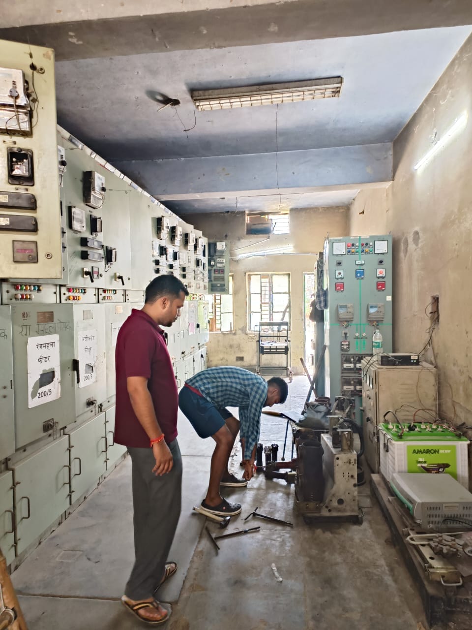 शाहजहांपुर में अब्दुल्लागंज उपकेंद्र के पैनल को सही करते कर्मचारी