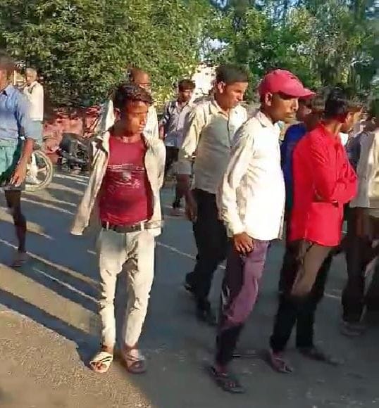 सड़क पर लेट कर जाम लगाने का प्रयास करते परिजन को हटाती पुलिस। वीडियो ग्रेब