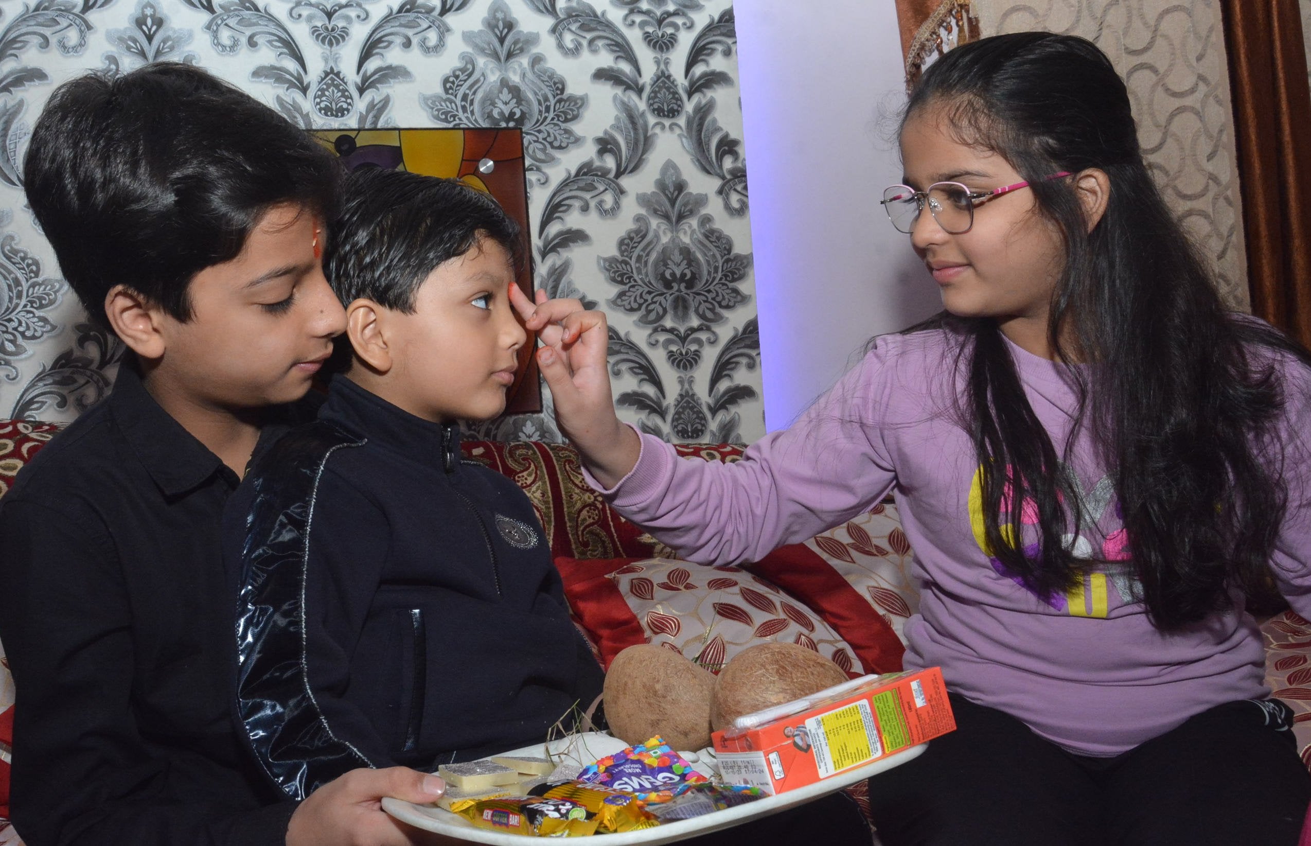 बुढ़ाना में भैयादूज के पर्व पर भाई कों तिलक करती हुई बहन । स्रोत संवाद।
