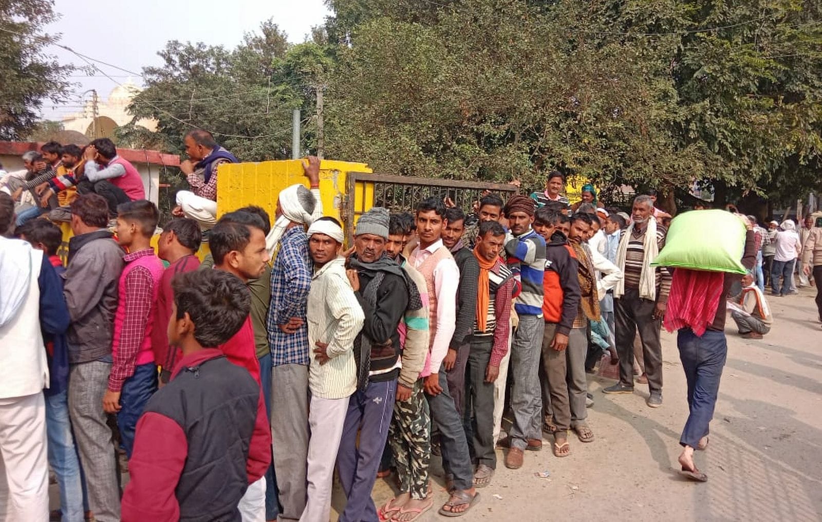 वजीरगंज के सहकारी केंद्र से डीएपी ले जाते किसान। संवाद