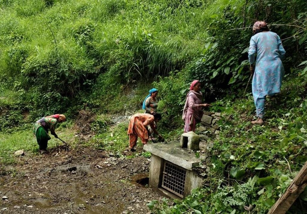 जोगिंद्रनगर में प्राकृतिक जल स्त्रोतों की सफाई करती महिलाएं। संवाद