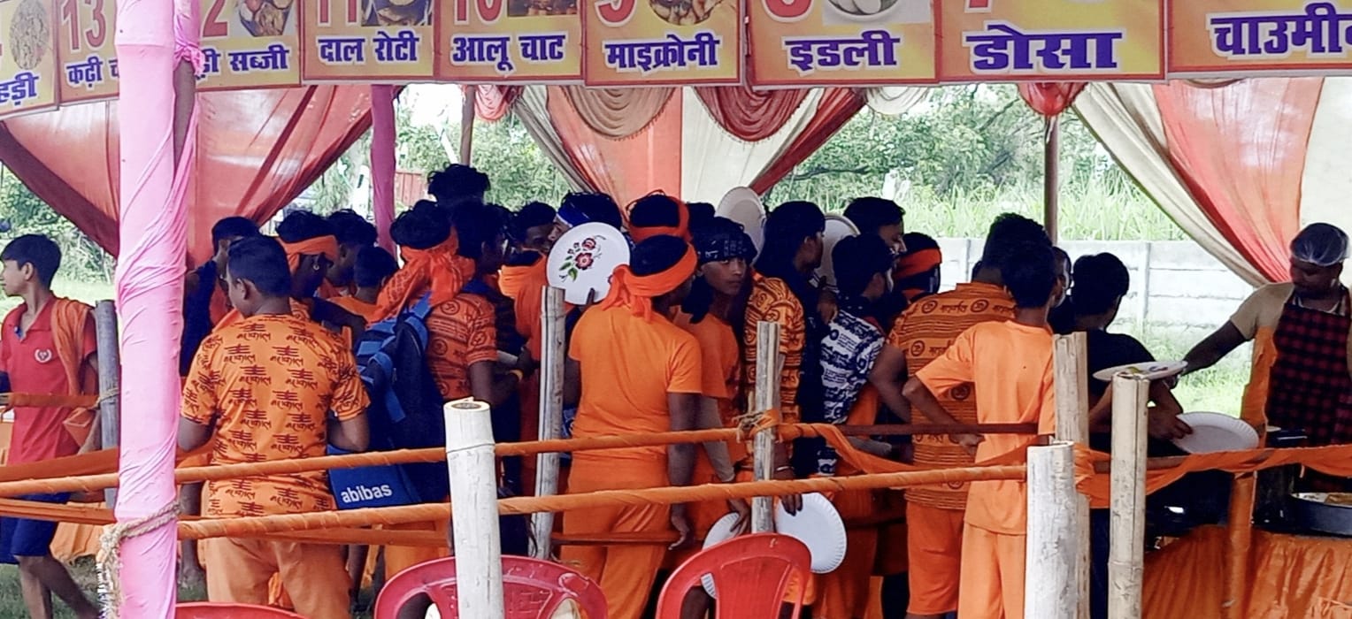 शिविर में अपने चप्पल व जूते ठीक करवाते कांवड़िए। संवाद शिविर में अपने चप्पल व जूते ठीक करवाते कांवड़िए। संवाद