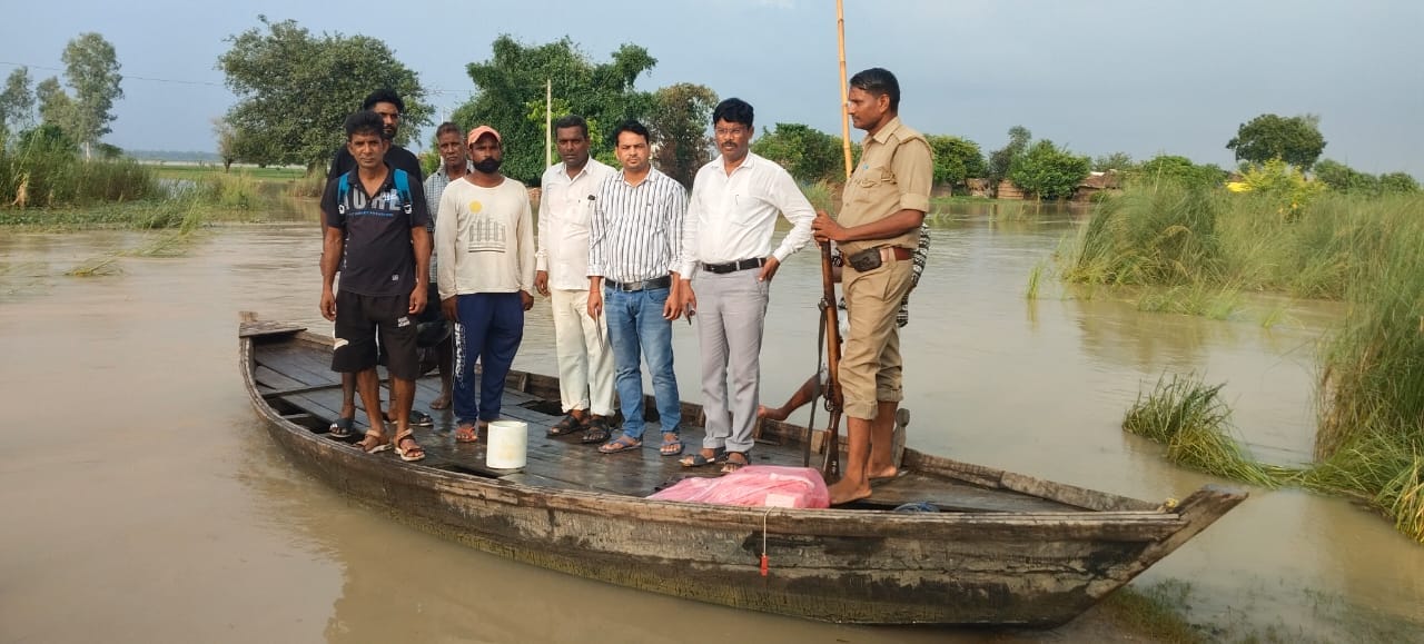 पलिया भीरा मार्ग पर बहता बाढ़ का पानी और निकलते वाहन। संवाद