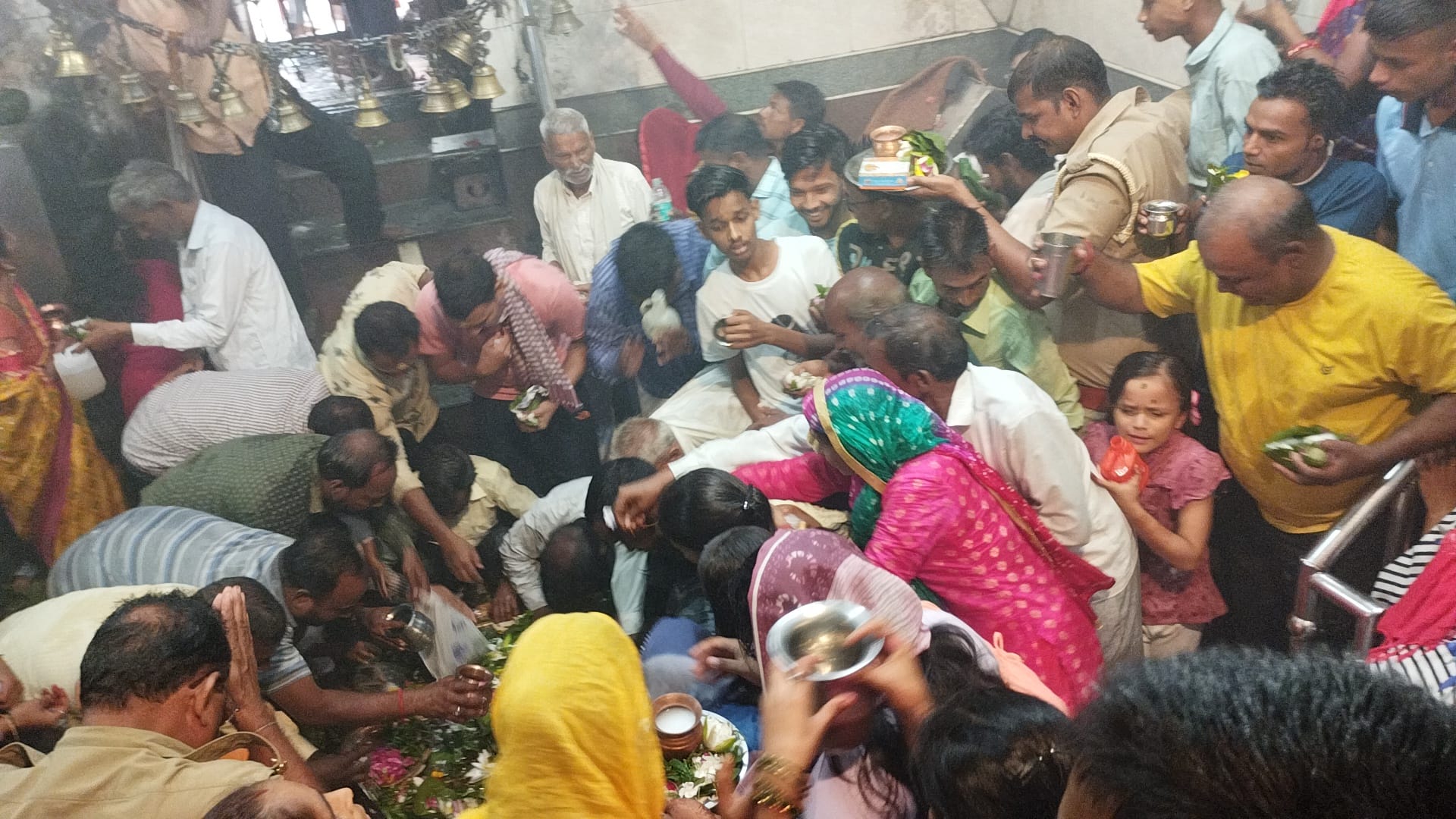 गोला में पौराणिक शिव मंदिर के गर्भ ग्रह के बाहर फूलों की थाली लिए खड़े शिव भक्त। संवाद गोला में पौराणिक शिव मंदिर के गर्भ ग्रह के बाहर फूलों की थाली लिए खड़े शिव भक्त। संवाद