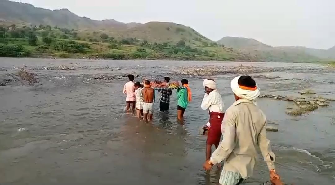 मरीज को खटिया पर लेटाकर नदी पार करते ग्रामीण