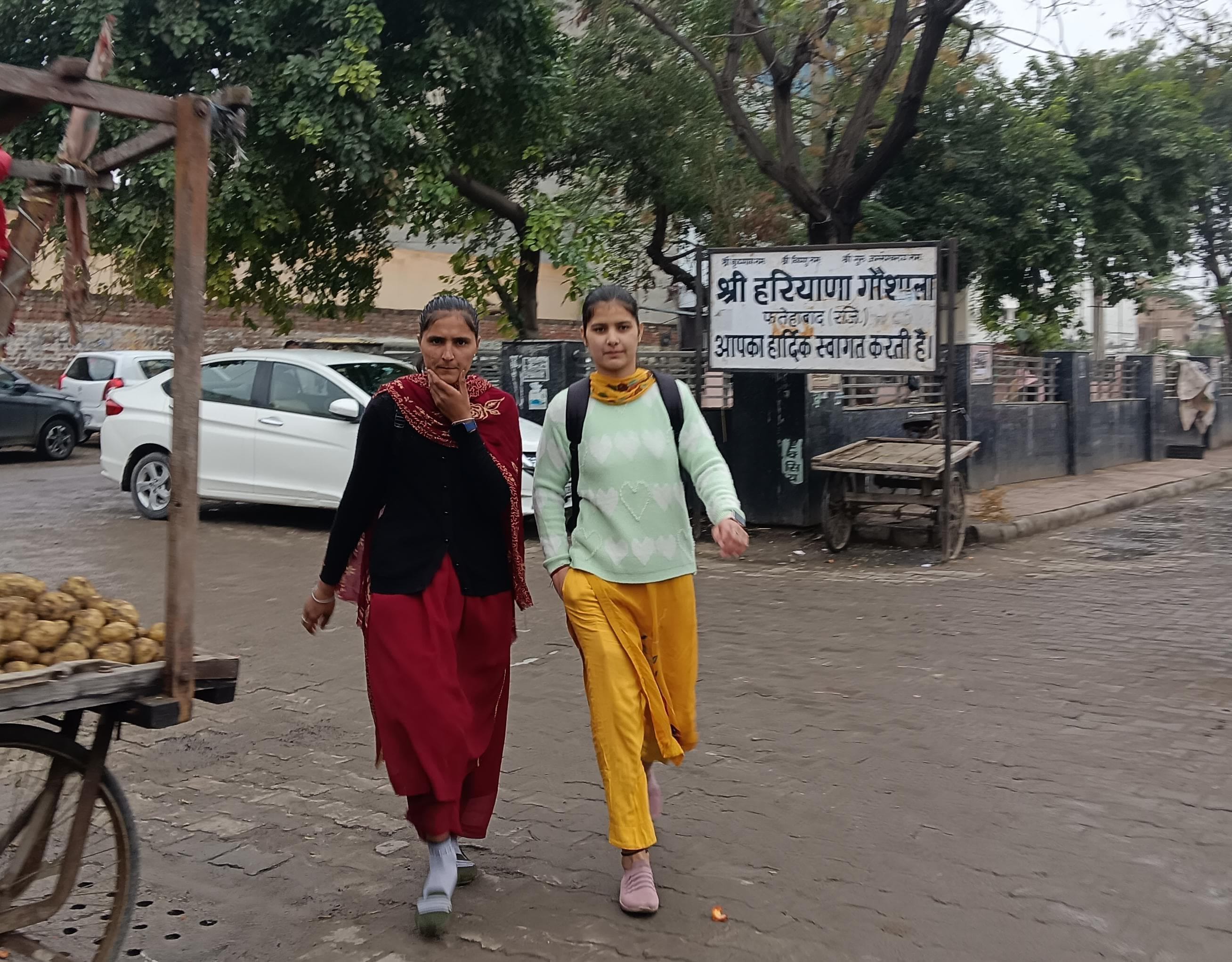 फतेहाबाद के पुराने बस अड्डे के बाहर धूप निकलने के बाद बस का इंतजार करते यात्री। संवाद
