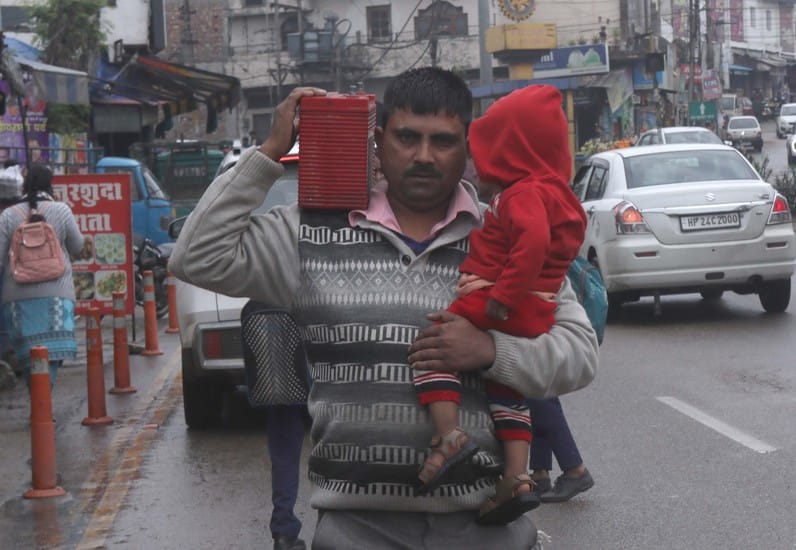 बैग न गिला हो जाए... ऊना में बारिश से बचने के लिए स्कूली छात्राओं से अपने कोट से ढके बैग की कित