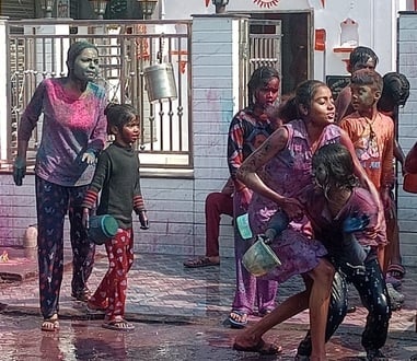 शहर की कृष्ण विहार कॉलोनी में होली खेलते लोग।संवाद