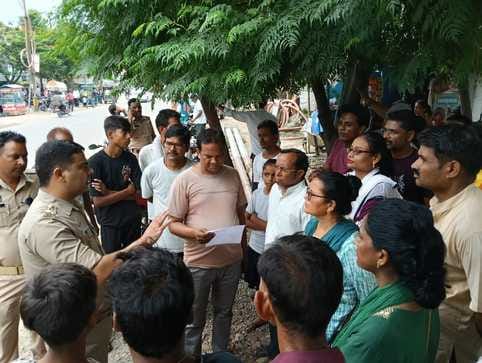टनकपुर हाईवे पर स्थित संतोषी माता मंदिर के गेट पर बैठी महिलाएं संवाद