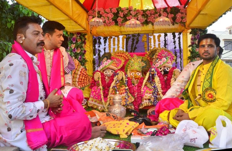 शहर में निकाली गई जगन्नाथ रथ यात्रा में भजन गाते लोग। संवाद