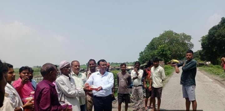 पलिया के कुंवरपुर खुर्द में राहत सामग्री का वितरण करते तहसीलकर्मी। स्रोत : तहसील प्रशासन