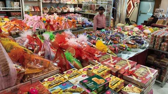 ज्वेलरी शोरूम पर चांदी की राखी पसंद करती महिला। संवाद