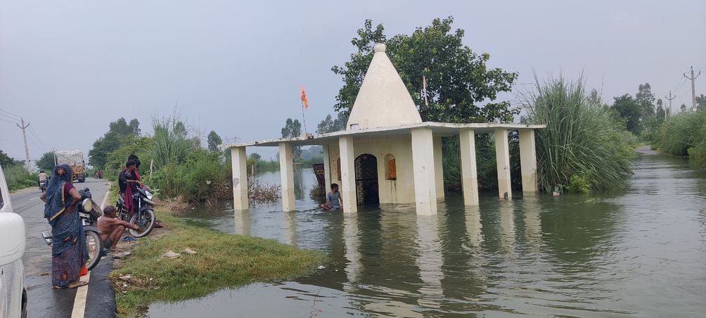फोटो नंबर 30-सनहा-गहोली मार्ग पर बाढ़ के पानी के बीच सुरक्षित स्थान पर जाते हमजापुर के ग्रामीण
