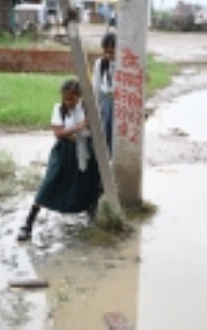 जलभराव से गुजरते लोग। जलभराव से गुजरते लोग।