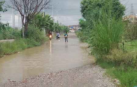 बारिश में जीटी रोड पर छाते के सहारे बच्चे को भीगने से बचाता युवक। संवाद बारिश में जीटी रोड पर छाते के सहारे बच्चे को भीगने से बचाता युवक। संवाद