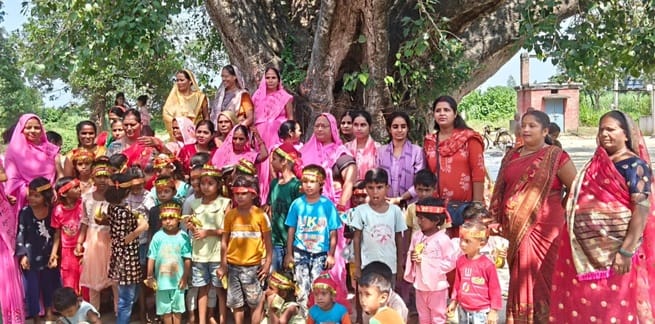 आंगनबाड़ी केंद्रों पर बच्चों के पोषण संबंधी पोस्टर के जरिये जानकारी देते कर्मी