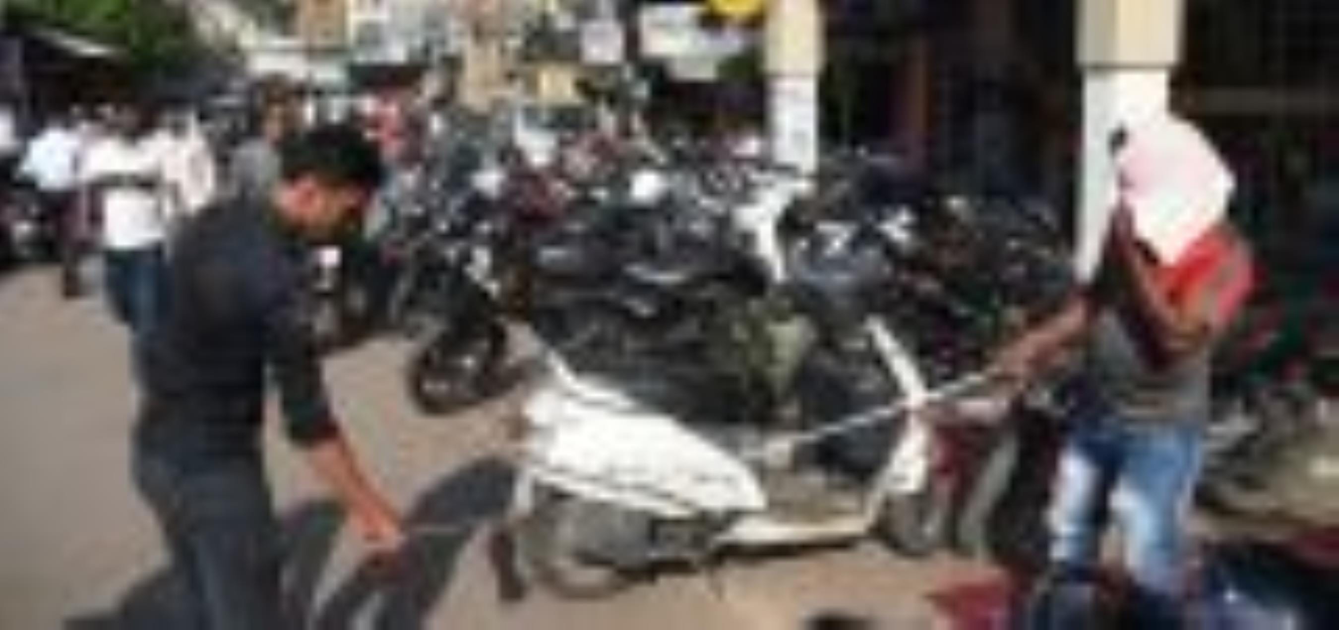 अमीनाबाद में सड़क पर खड़ी गाड़िया।