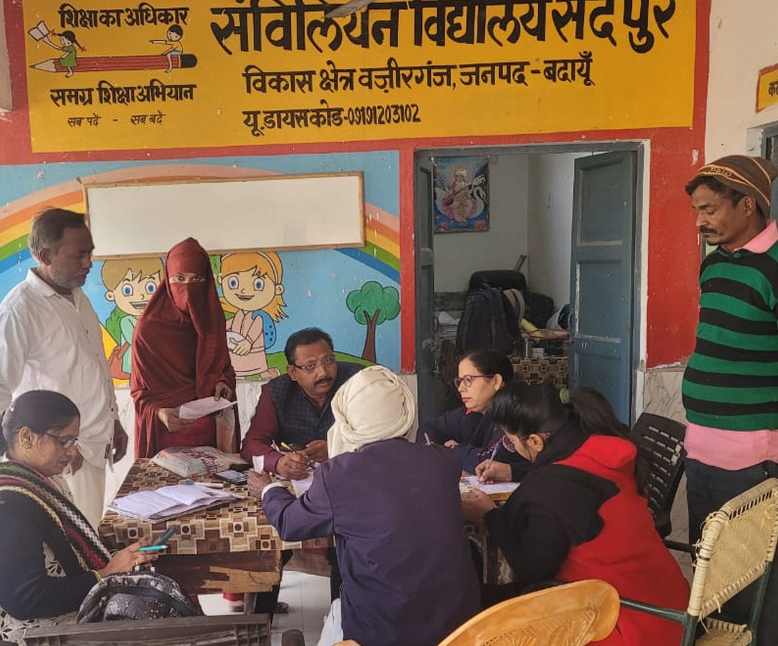 संविलियन विद्यालय में एसआईआर फॉर्म भरते लोग। संवाद