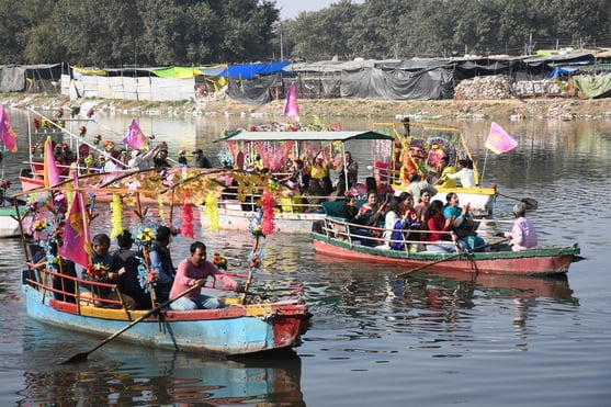 गोमती नदी में निकाली नौकाओं की भव्य शोभायात्रा में शामिल कलाकार। -अमर उजाला