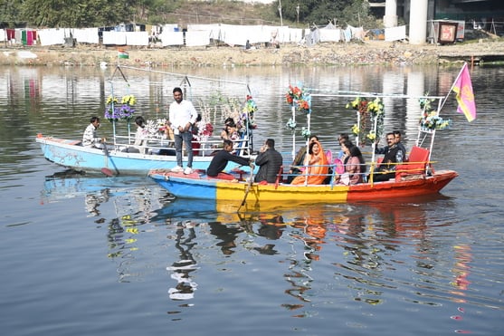 गोमती नदी में निकाली नौकाओं की भव्य शोभायात्रा में शामिल कलाकार। -अमर उजाला
