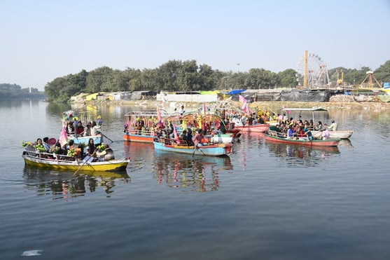 गोमती नदी में निकाली नौकाओं की भव्य शोभायात्रा में शामिल कलाकार। -अमर उजाला