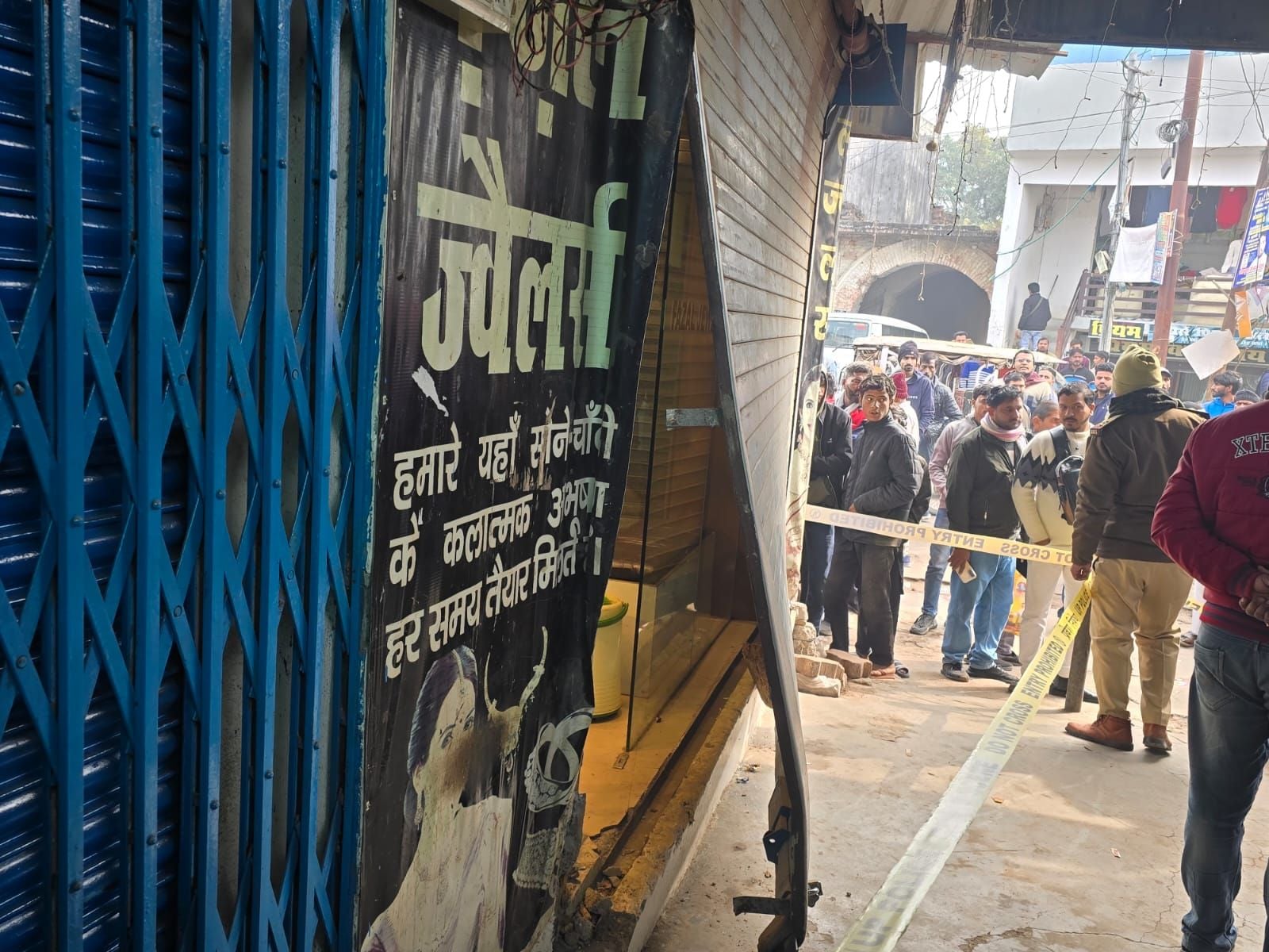 मलिहाबाद में दुकान का टूटा शटर व घटना की जांच करती पुलिस। मलिहाबाद में दुकान का टूटा शटर व घटना की जांच करती पुलिस।