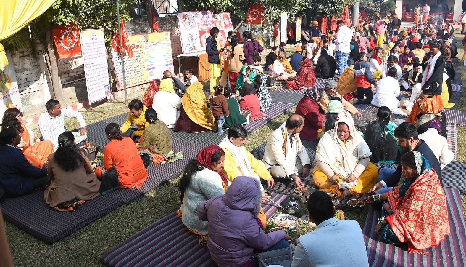 जानकीपुरम स्थित मदर्स प्राइड स्कूल के प्रांगण में कार्यक्रम के दौरान आहुति देते लोग।