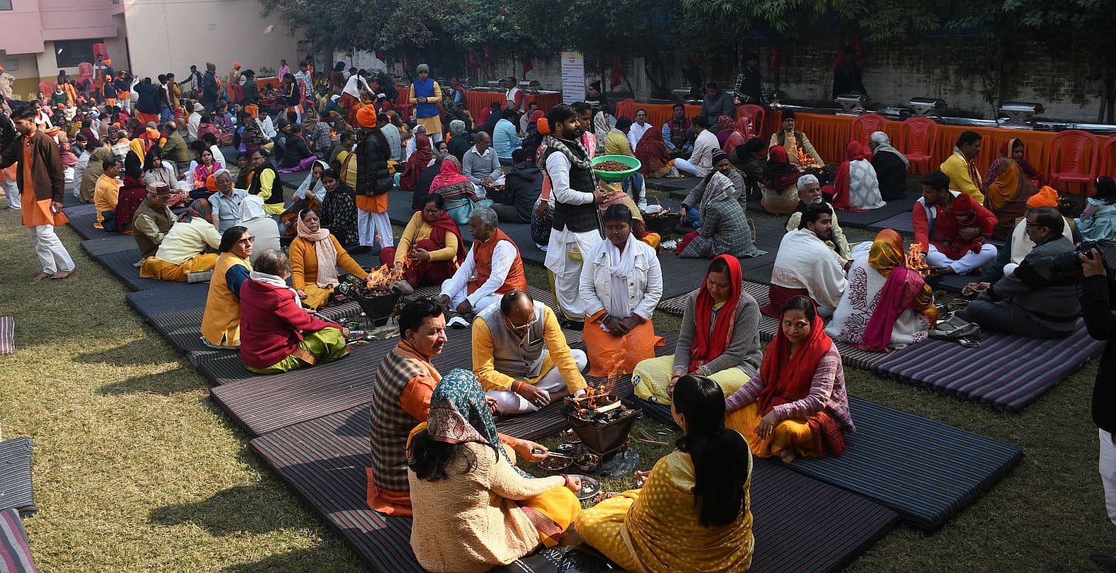 जानकीपुरम स्थित मदर्स प्राइड स्कूल के प्रांगण में कार्यक्रम के दौरान आहुति देते लोग।