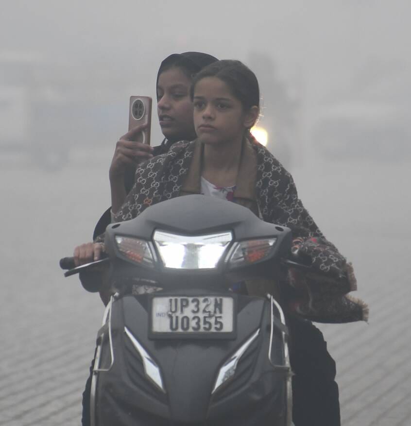 शुक्रवार की सुबह कोहरे के बीच निकले लोग। शुक्रवार की सुबह कोहरे के बीच निकले लोग।