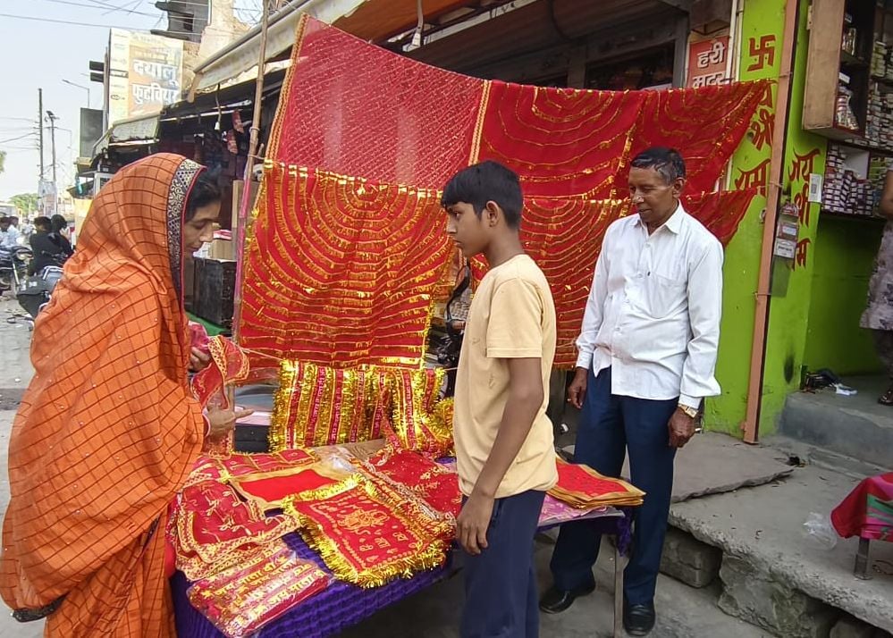 शहर में मूर्ति की खरीददारी करती महिला। संवाद शहर में मूर्ति की खरीददारी करती महिला। संवाद