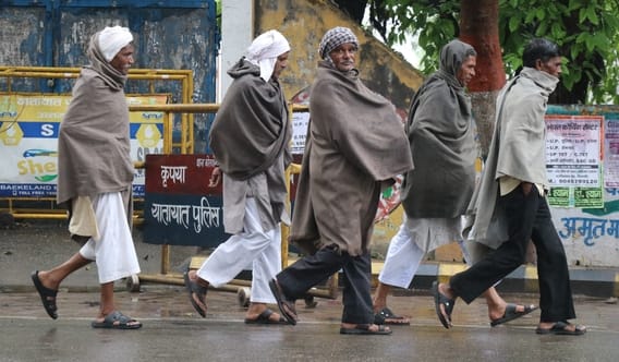 बिजनौर में शुक्रवार को हुई बारिश में बच्चों को छाता लगाकर ले जाती महिलाएं। संवाद