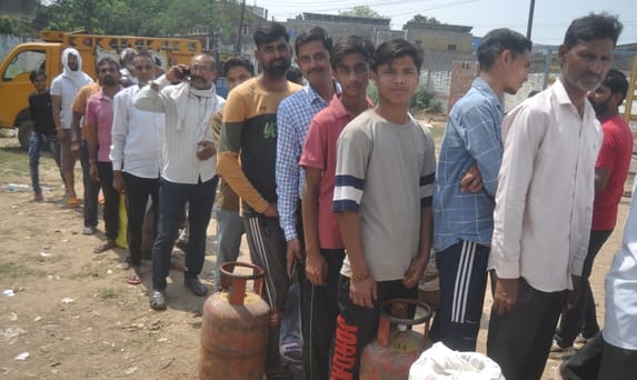 सिकंदर गेट पर गैस सिलिंडर न मिलने के कारण होटल पर लकड़ी जलाकर चूल्हें पर खाना बनाते युवक।संवाद