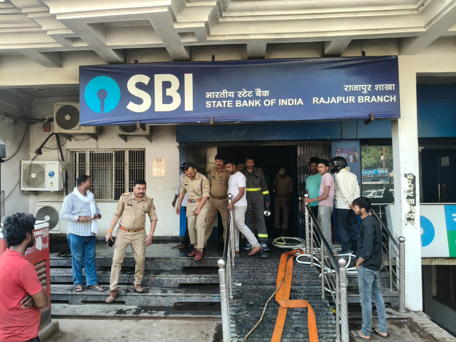 फोटो- 30सीकेटीपी 16 एसबीआई में लगी आग बुझाते दमकल कर्मचारी व मौजूद अन्य।संवाद