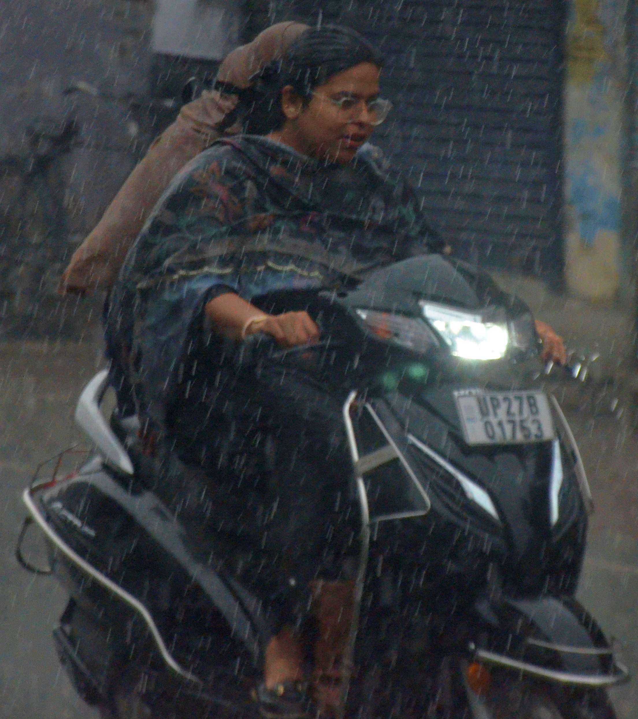 पुवायां मंडी में तिरपाल से ढके गेहूं के ढेर और छाए बादल। संवाद