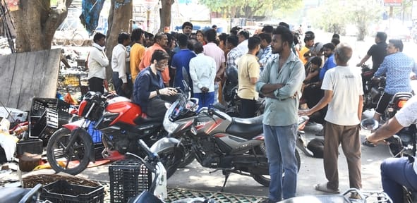 आग बुझने के बाद सामान ढूंढते लोग।