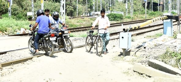 रेलवे क्रॉसिंग को पार करते लोग। रेलवे क्रॉसिंग को पार करते लोग।